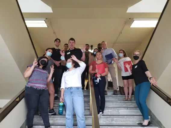 Group of students standing on stairs.