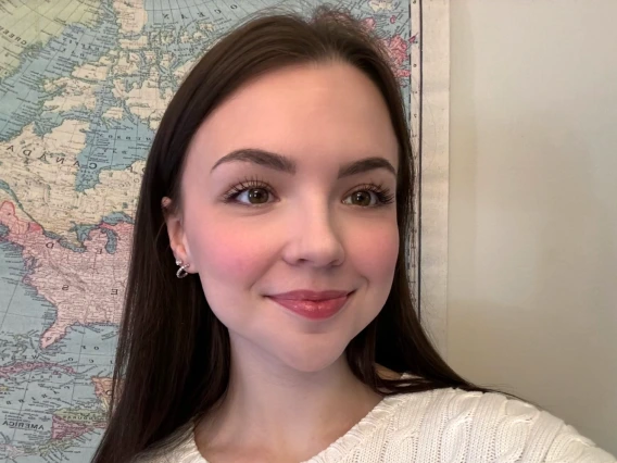 Charlotte McTaggart smiling in front of map