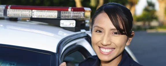 Female police officer next to squad car